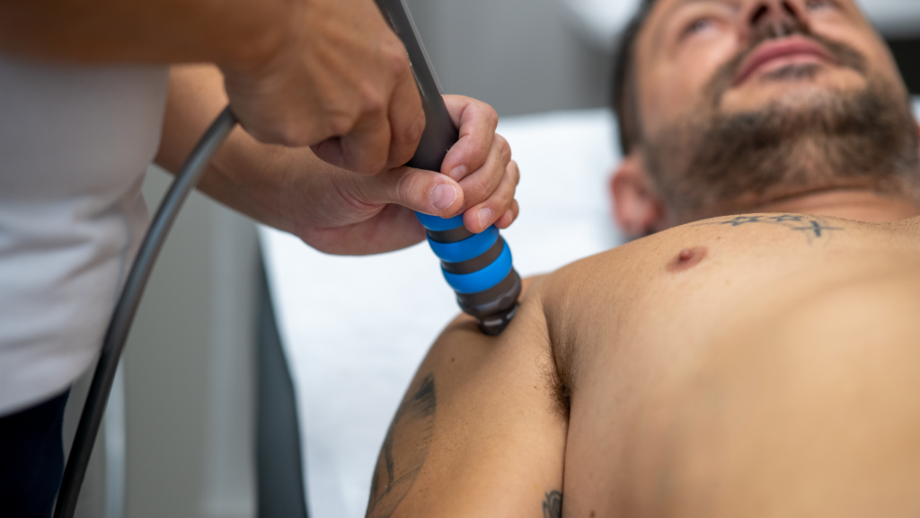A man lies on his back and receives shockwave therapy in Pitt Meadows.