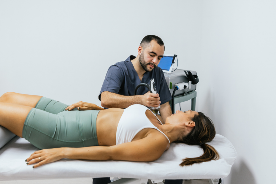 A woman reclines on her back while receiving shockwave therapy in Pitt Meadows.
