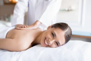 smiling patient as chiropractic care helps support back pain in Pitt Meadows. Pre Kinetic Wellness 